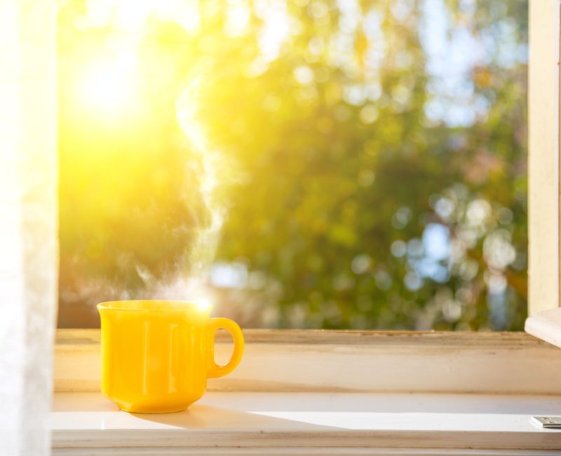 YELLOW MUG OF HOT TEA